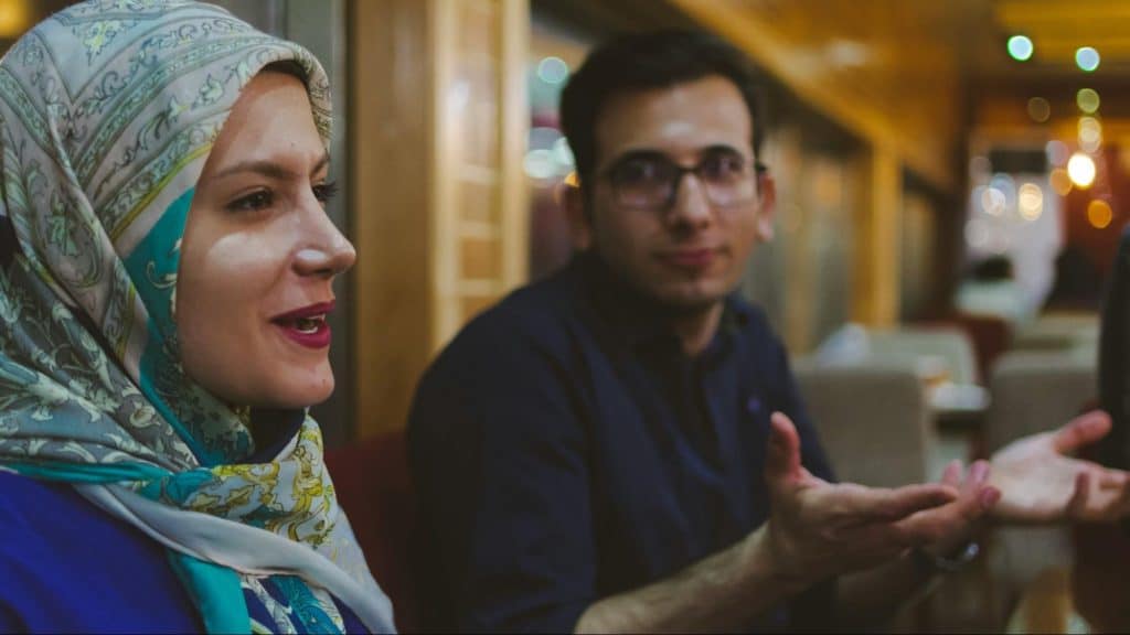 A man explaining to woman 