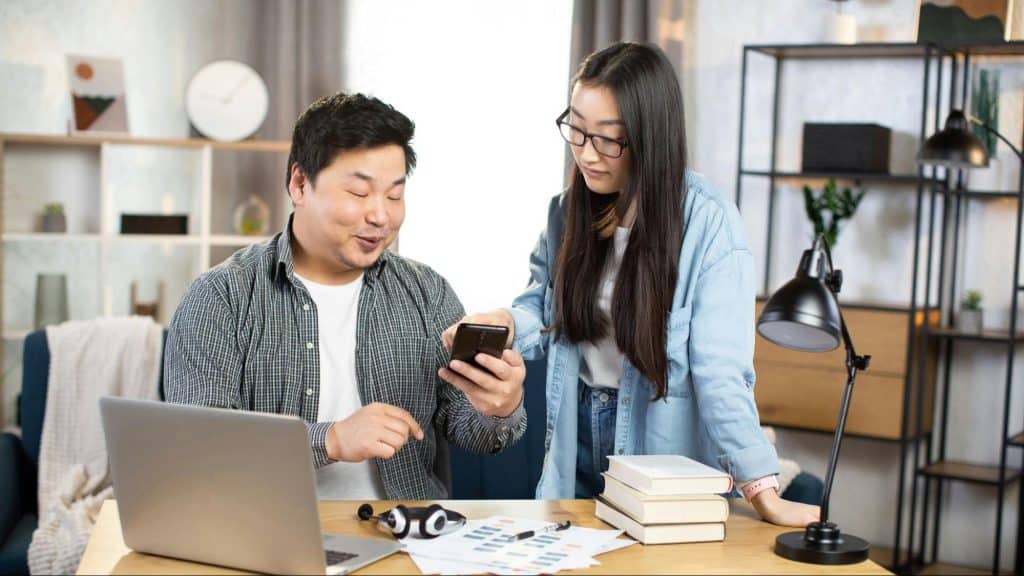 A man showing something to woman