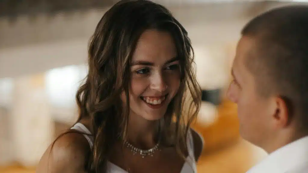 A woman smiling at a man.