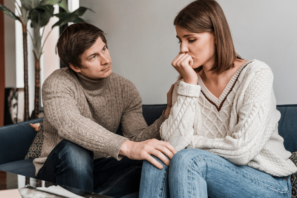 Woman thinking and a man trying to speak with her