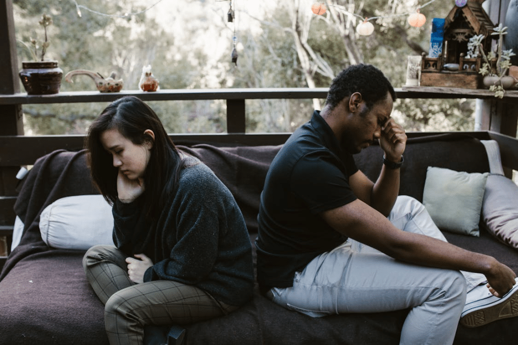 Unhappy man and Woman Sitting Back to Back