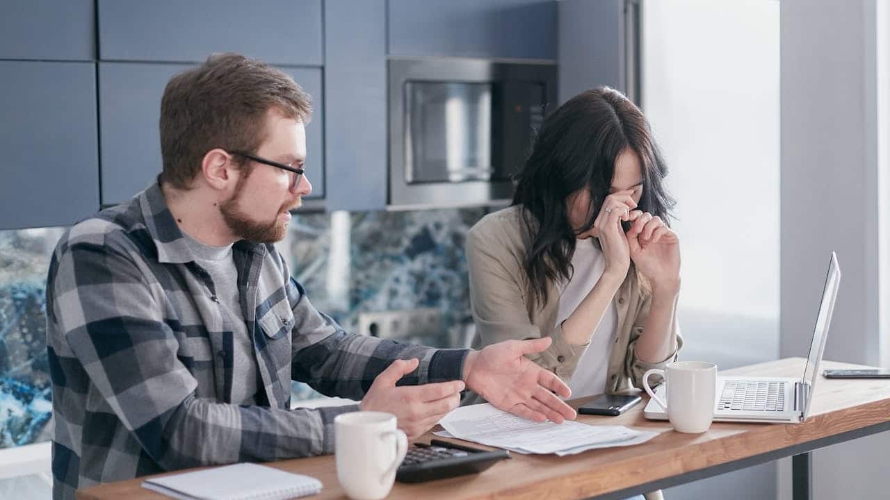 A man looking upset at his girlfriend