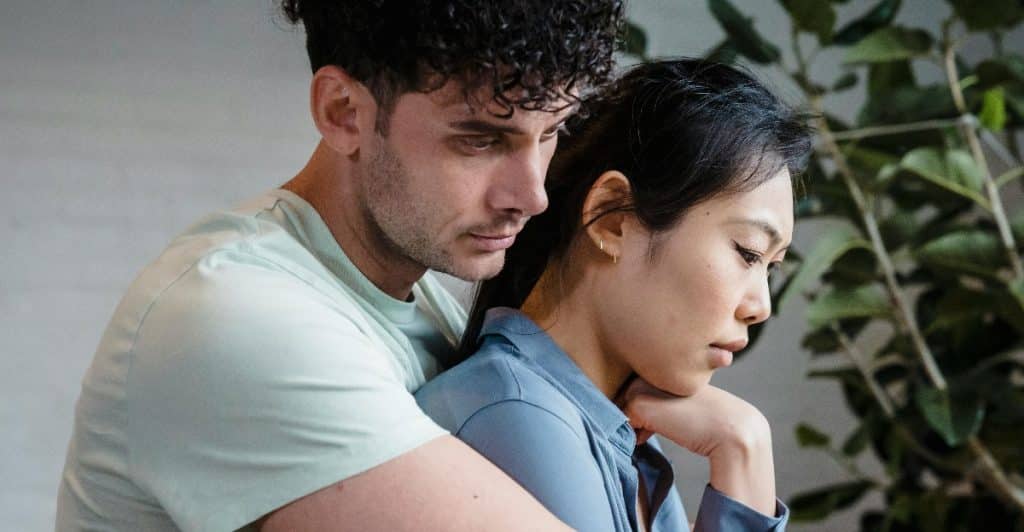 Portrait of a Sad Couple Embracing