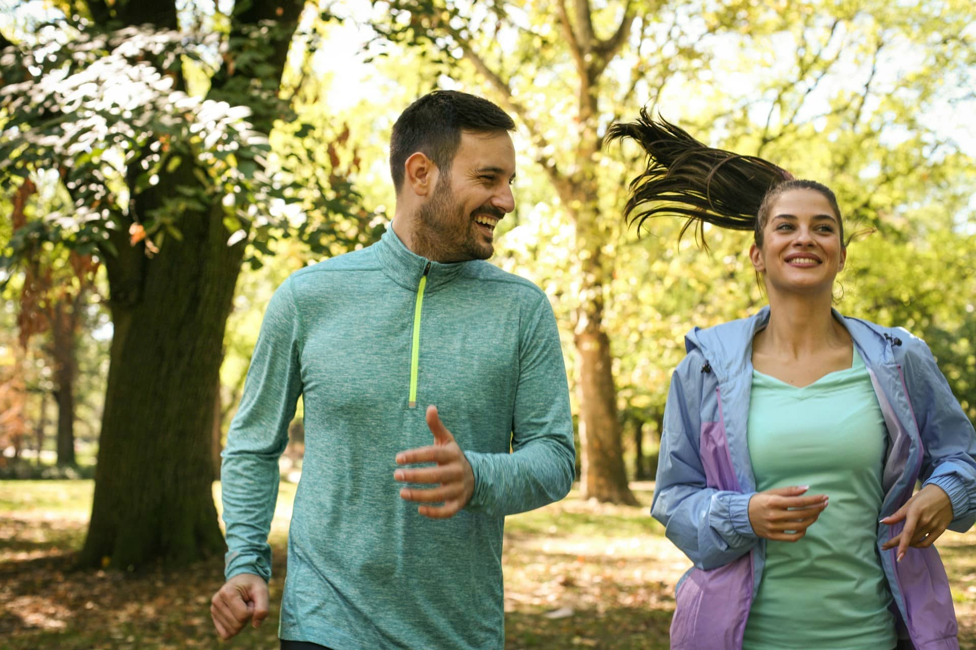 A couple jogging in the park.