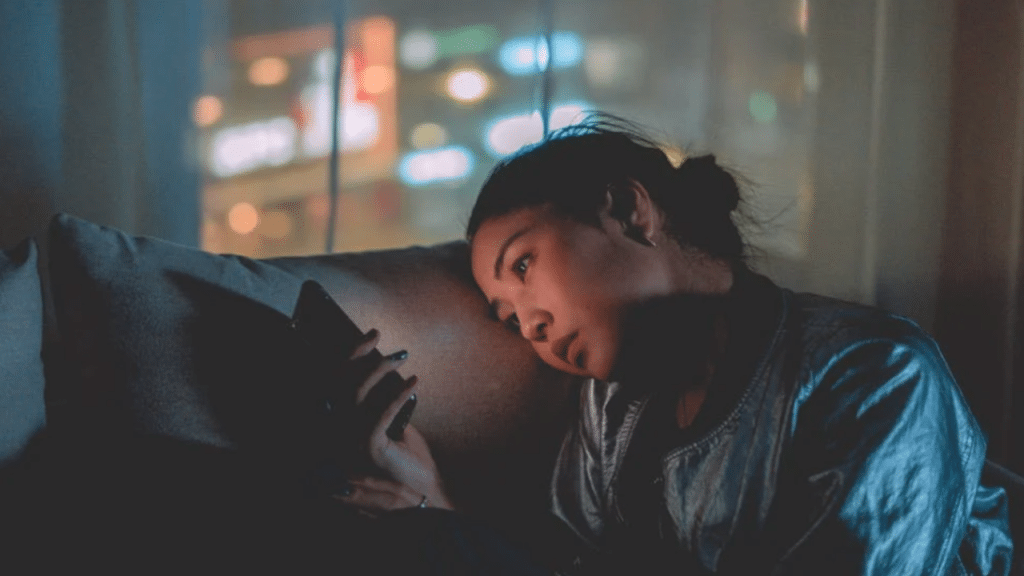 A woman looking sad while texting