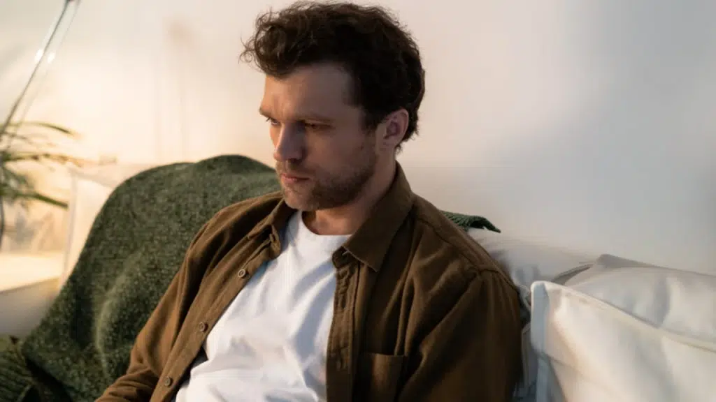 A man looking sad on the sofa