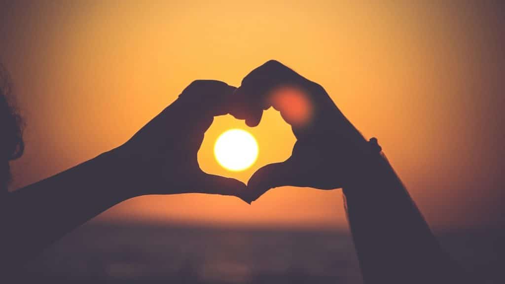 A couple holding hands in the form of a heart.