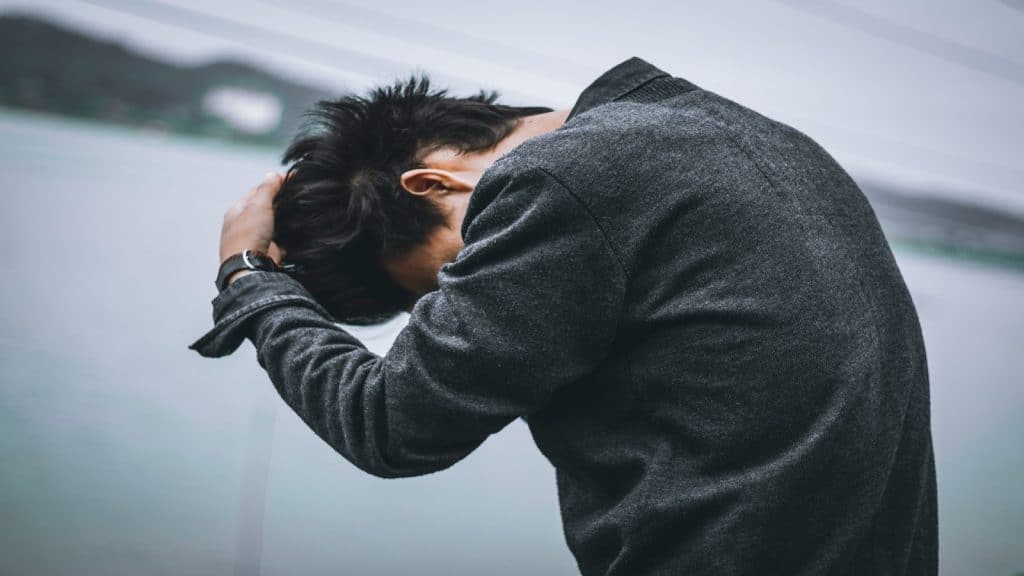 person holding back emotionally