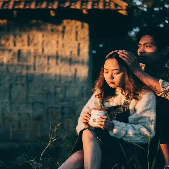 couple sitting close but with a sense of emotional distance