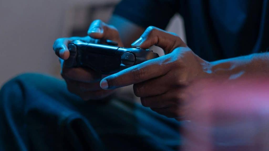 A person holding a video game controller while playing.