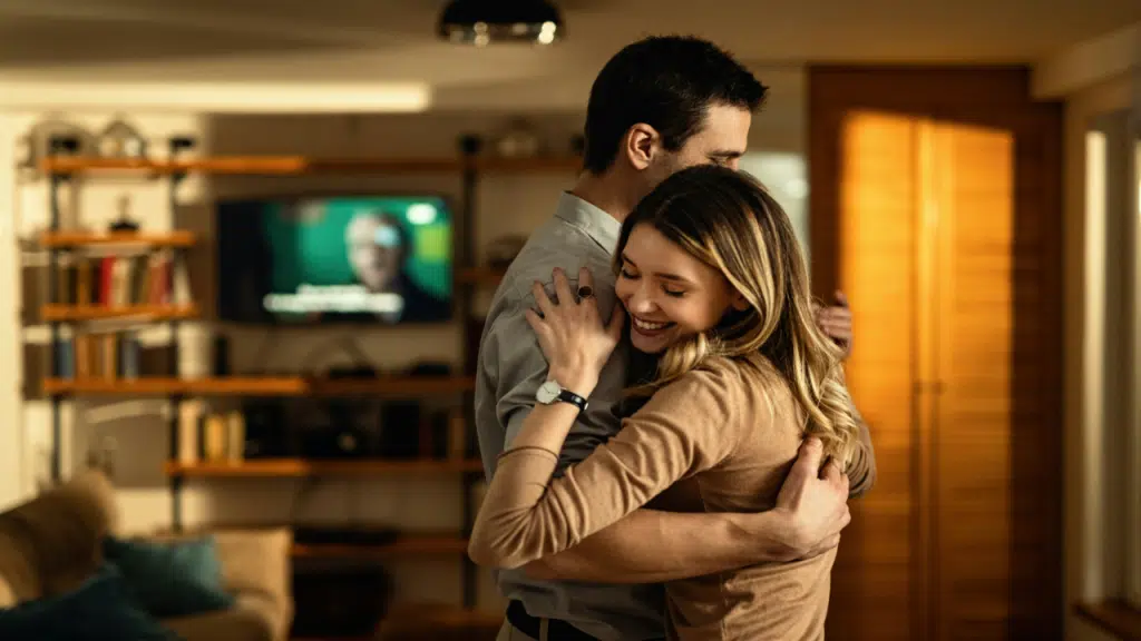 A couple dancing in the living room