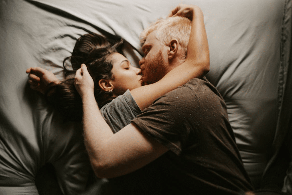 A couple kissing in bed