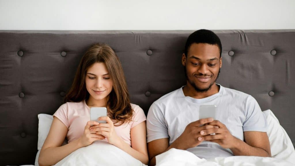 A man and woman busy with their phones