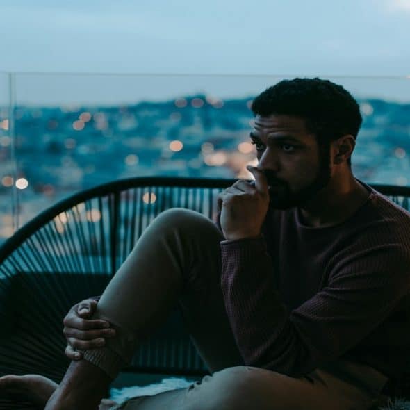 man sitting alone, thinking seriously