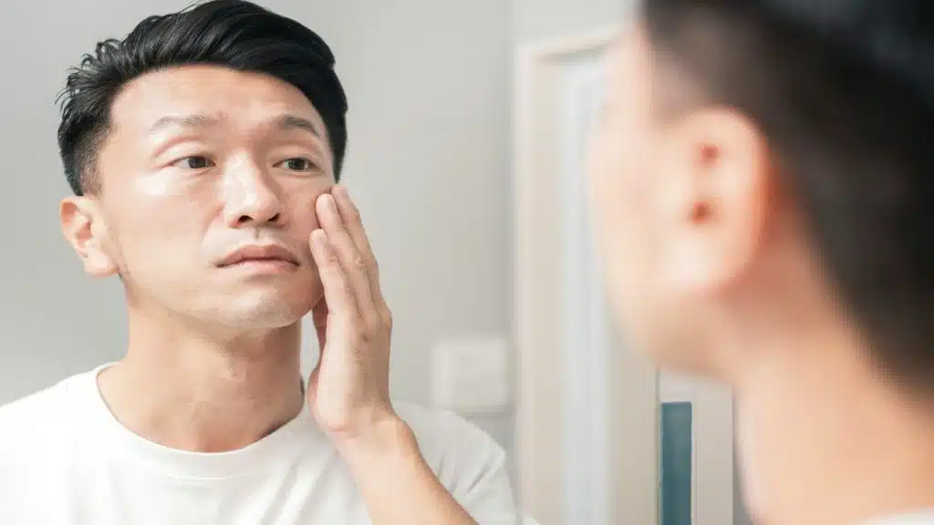 man noticing physical appearance