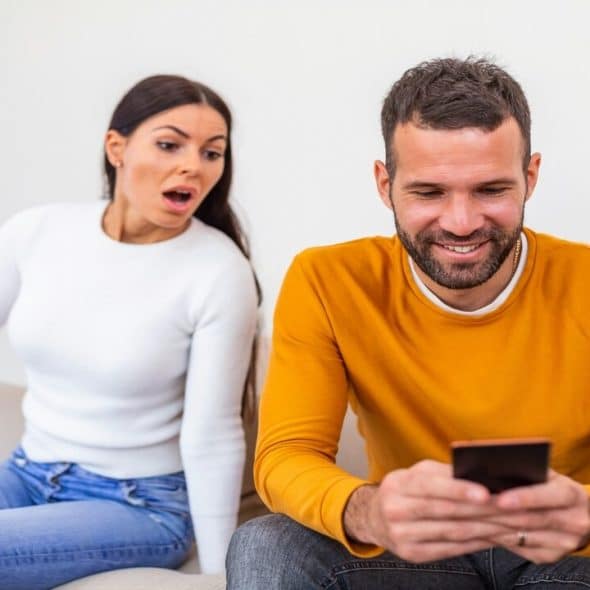 A woman shocked at her partner’s phone