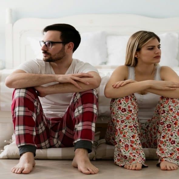 couple sitting together but emotionally distant