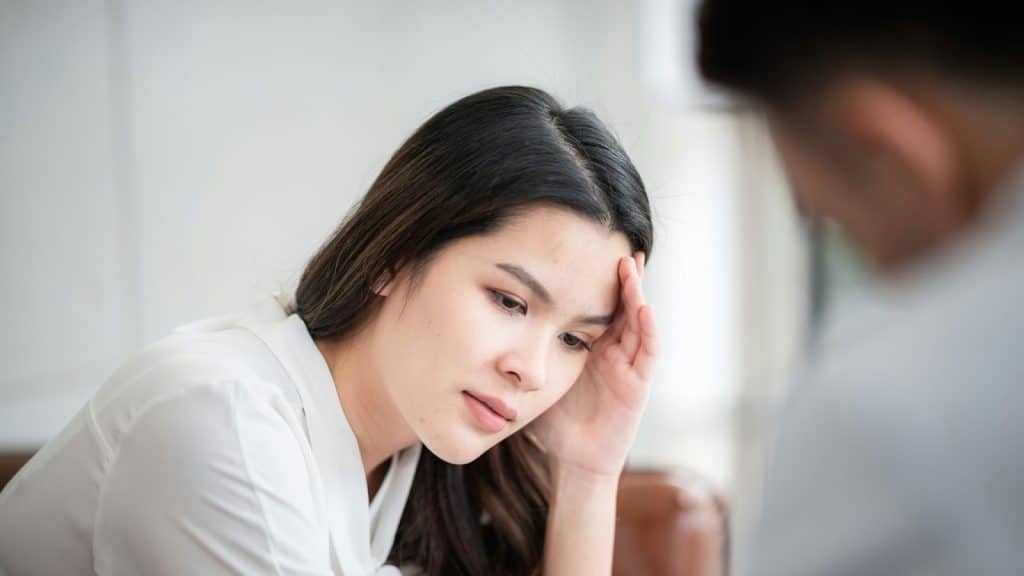 A woman holding her head