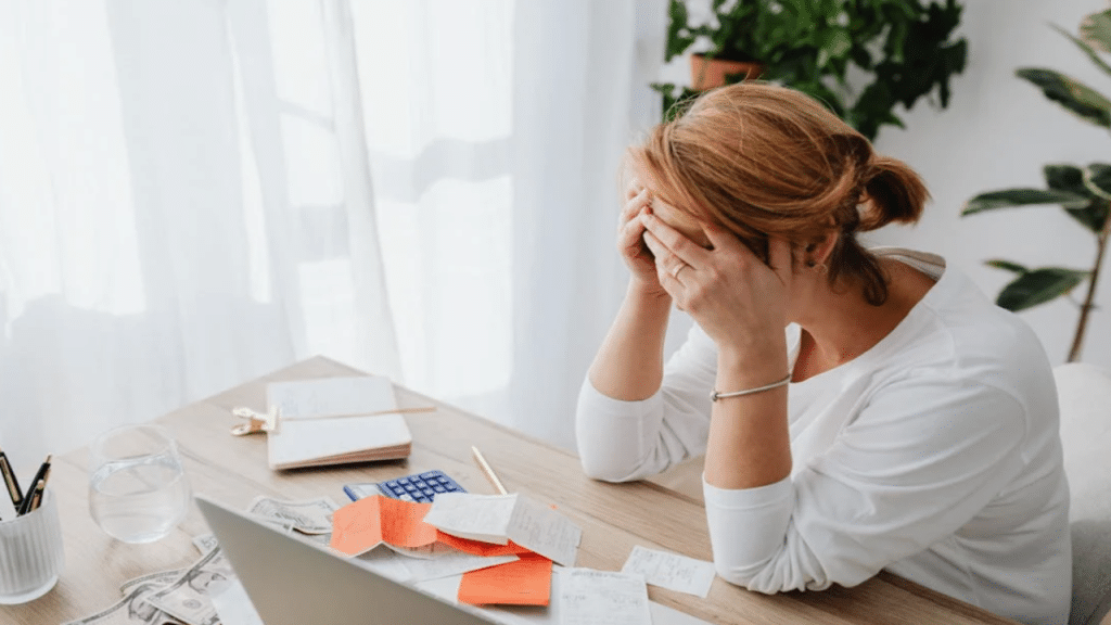 A woman stressed over receipts
