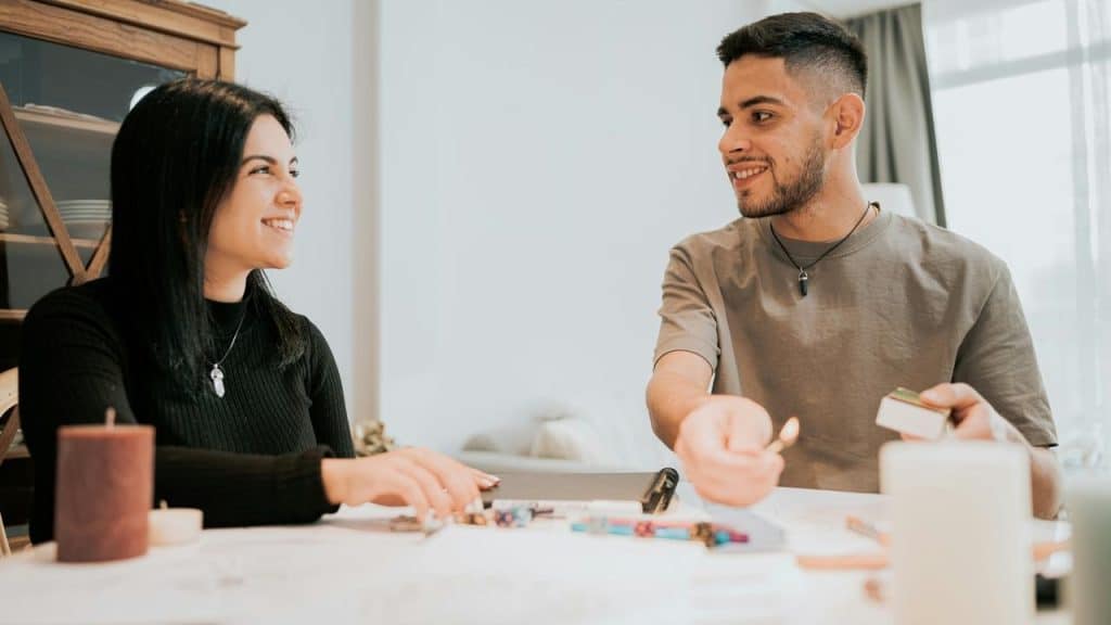 A smiling man and woman sitting at a table