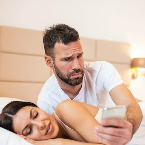 Jealous husband spying on his wife's phone.