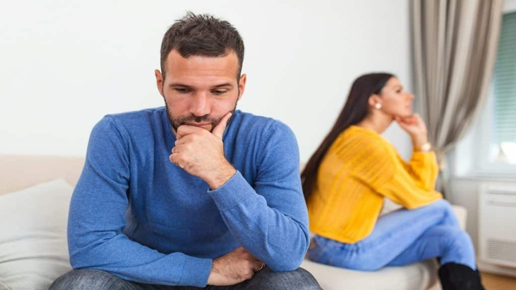 man sitting across from partner looking thoughtful
