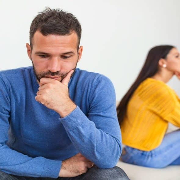man sitting across from partner looking thoughtful
