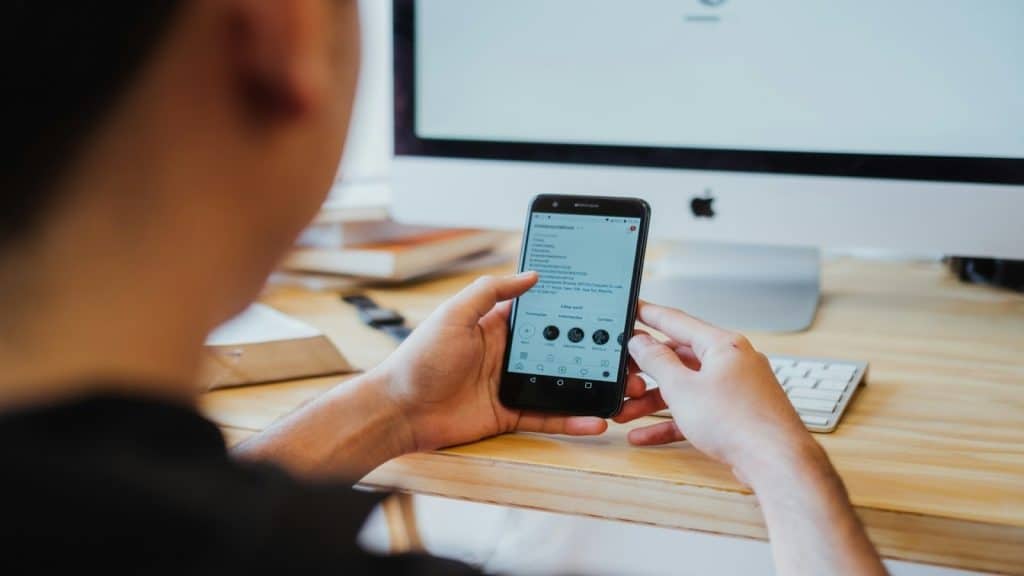 man checking phone with multiple conversations