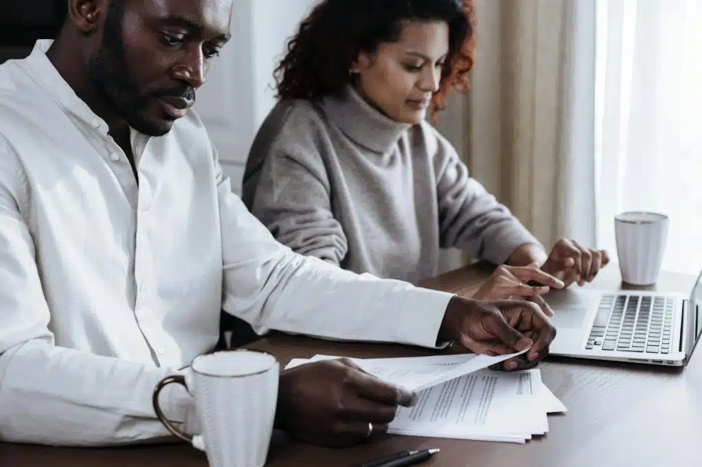 A man and woman busy with documents 