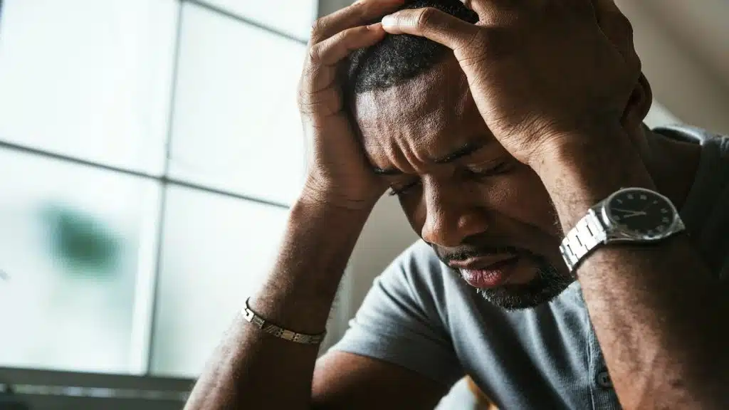 man looking stressed while thinking