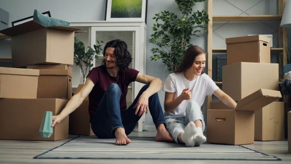 A man and woman just moved  in on their new apartment
