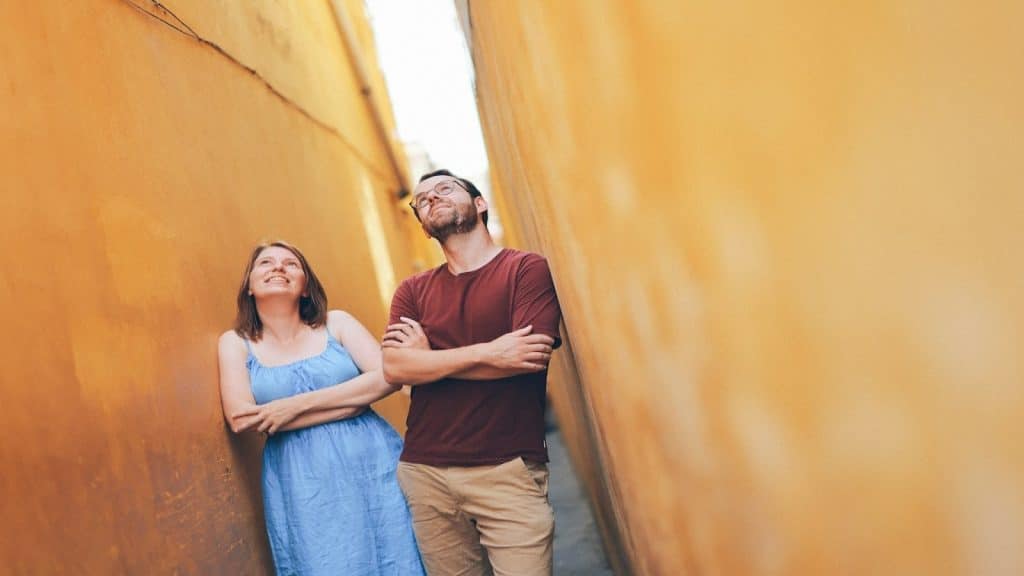 couple standing together but looking in different directions
