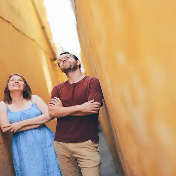 couple standing together but looking in different directions