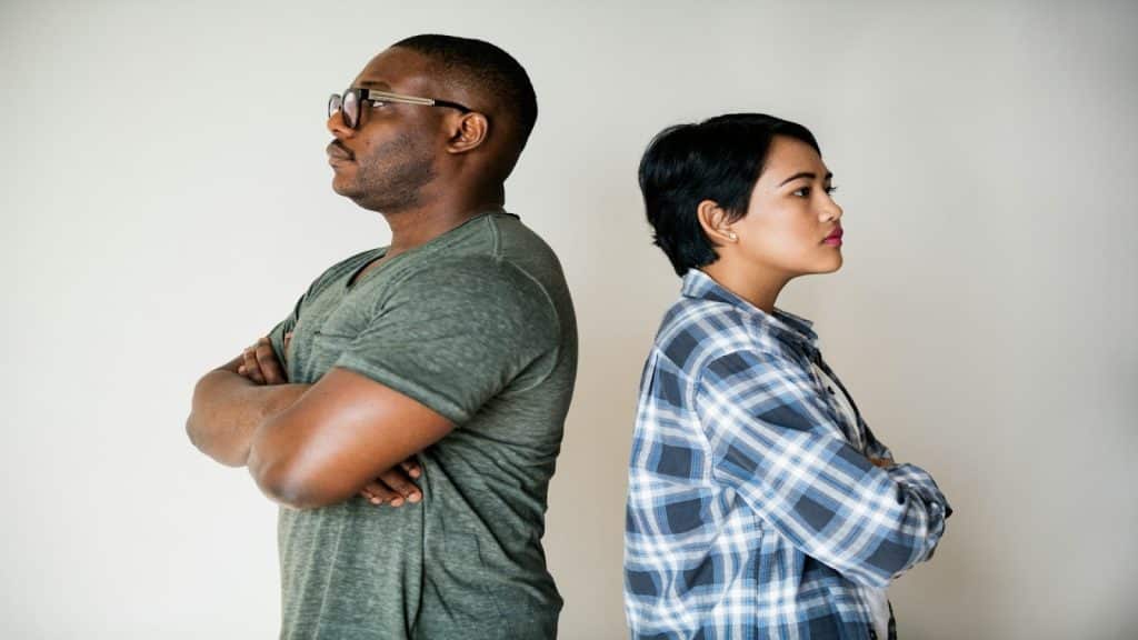 couple standing apart thoughtfully