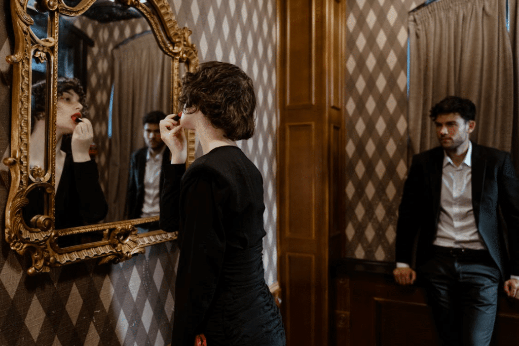 A Woman Looking at the Mirror with a Man