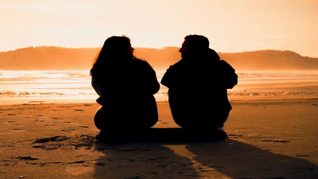 couple sitting together in silence with visible distance