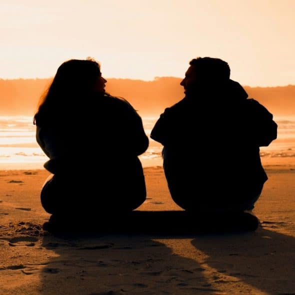 couple sitting together in silence with visible distance