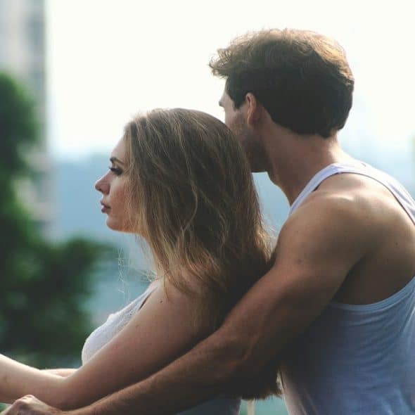 couple sitting closely together with a relaxed but uncertain mood
