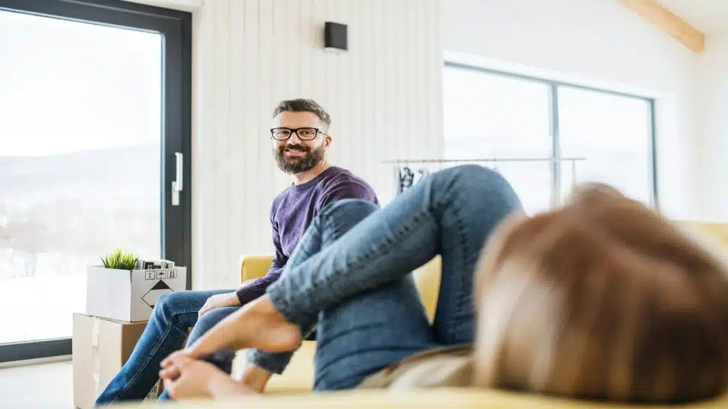 man appearing relaxed while partner looks distant