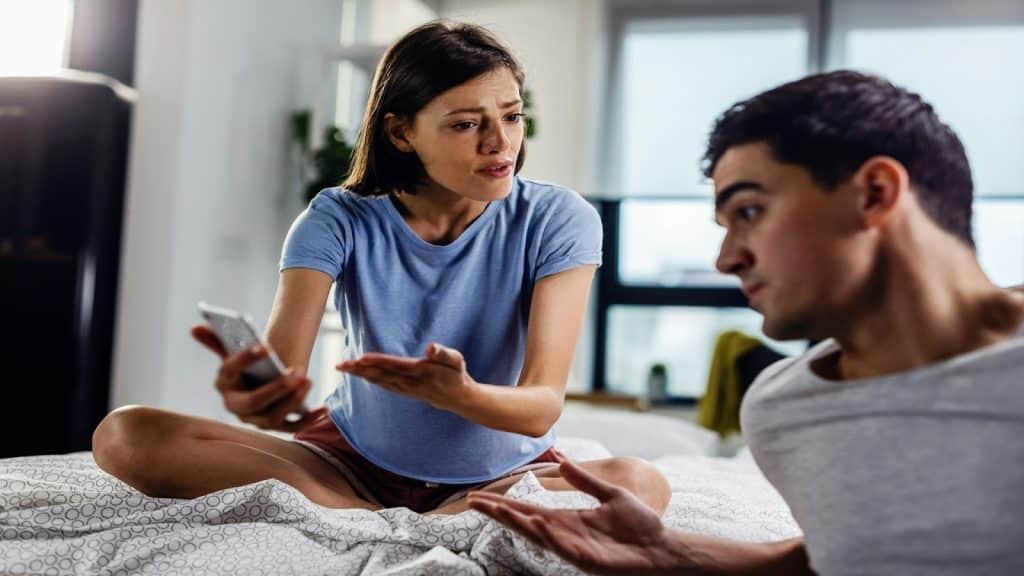 man distracted while partner is speaking