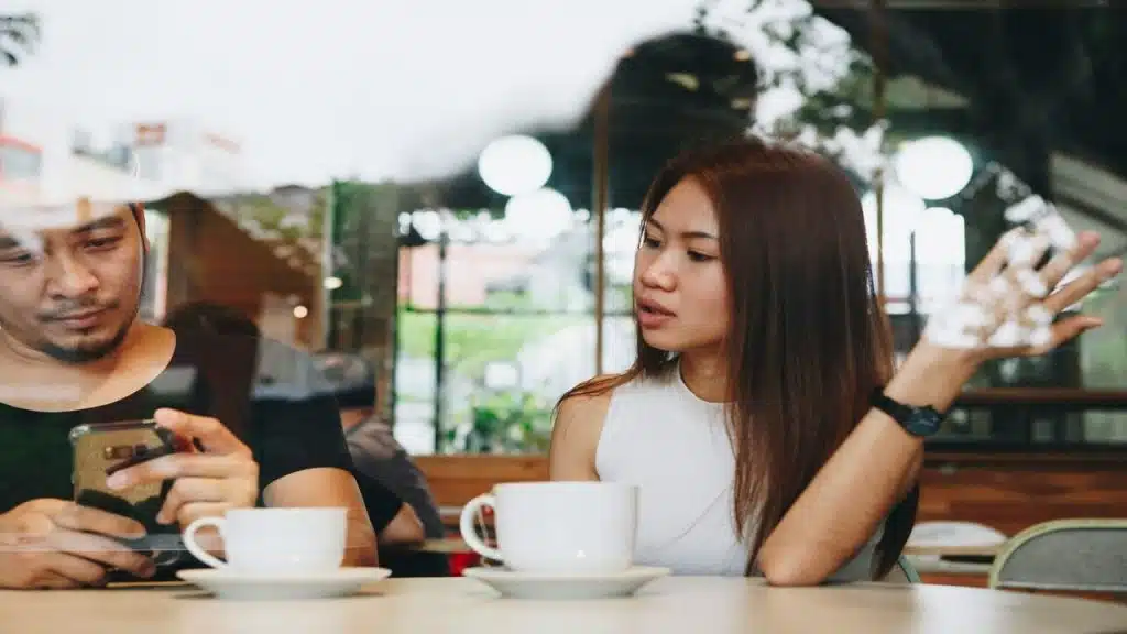 A man using his phone during a date