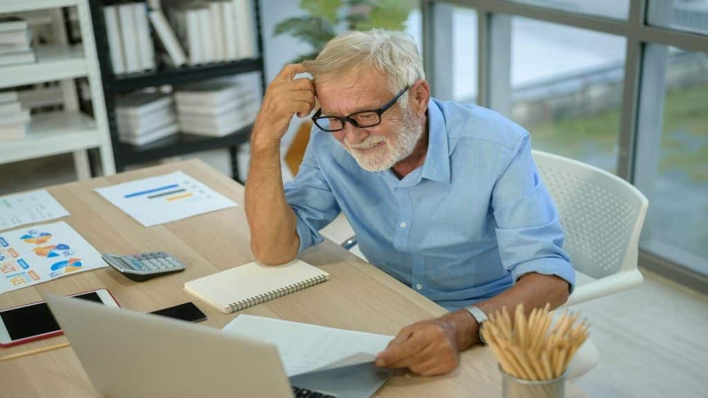 A senior man working in the office