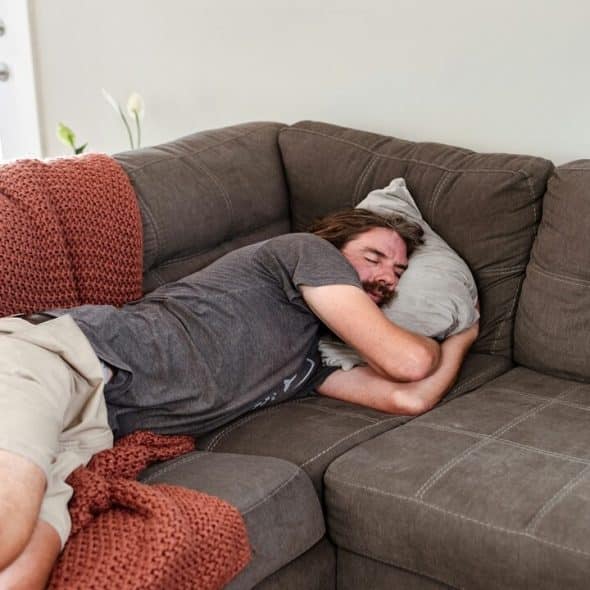 A man sleeping on the couch