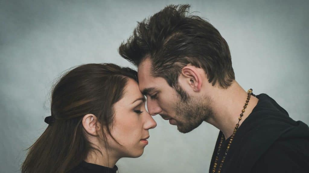 Man and woman touching foreheads.