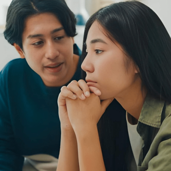 Sad woman ignoring man trying to talk to her