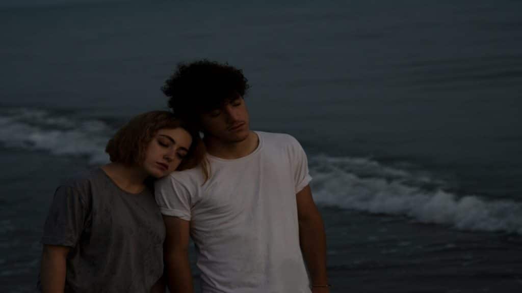A sad couple by the beach