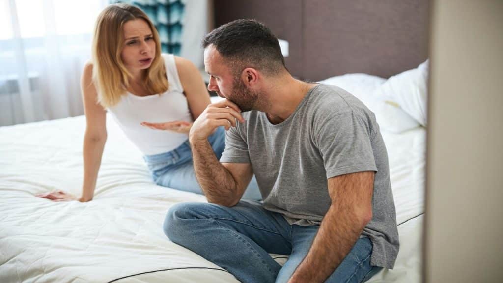 A couple having a serious talk in bed
