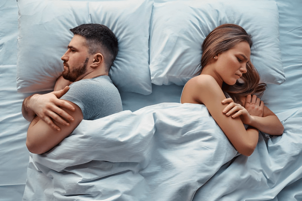 couple lying in bed turned back to back
