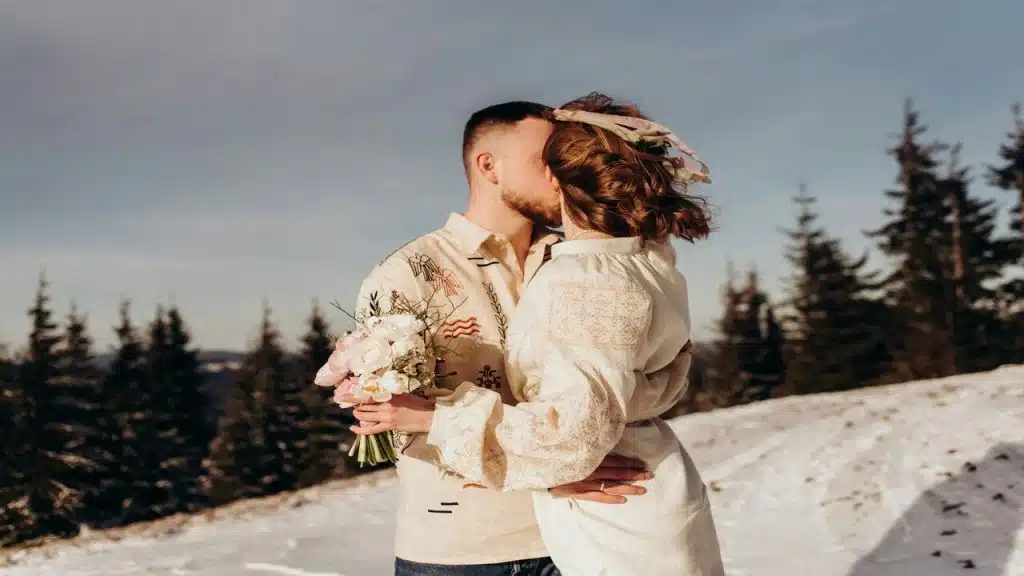 A man giving his girlfriend a bouquet of flowers