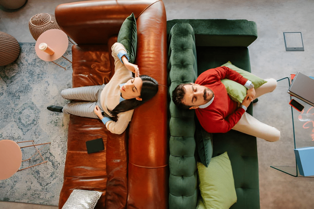 Couple sitting apart on different couches